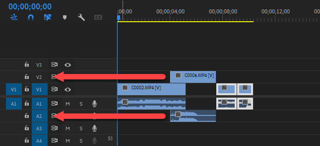 Screenshot of two red arrows on Adobe Premiere Pro sequences V2 and A2 tracks pointing track labels